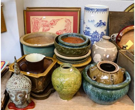 A modern Chinese blue and white stick stand, together with various Chinese earthenware planters, an olive glazed wine vessel,