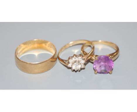 Three modern 9ct gold rings, including single stone amethyst and a wedding band, gross 6.7 grams.