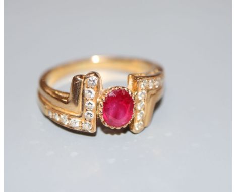 A modern 750 yellow metal, ruby and diamond dress ring, size M, gross 4.8 grams.CONDITION: No visible damage to any of the st