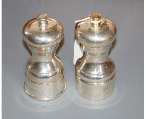 A pair of modern silver pepper mills, David R. Mills, London, 1995 &amp; 1998, 11.1cm, one with gilded finial.CONDITION: Over