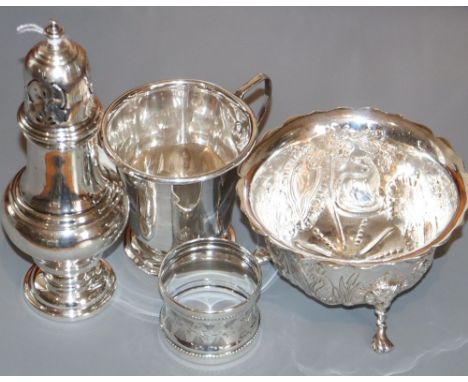 A George V silver sugar caster, an Edwardian silver sugar bowl, a silver christening mug (marks rubbed) and a silver napkin r