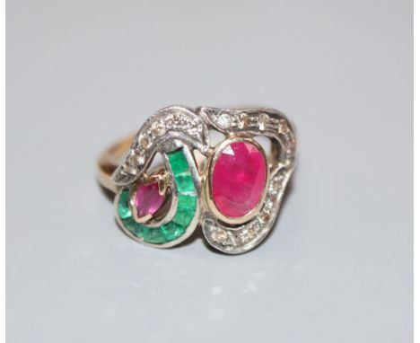 A modern 14k, ruby, emerald and diamond set dress ring, size J, gross 3.1 grams.CONDITION: One emerald is chipped. Two of the