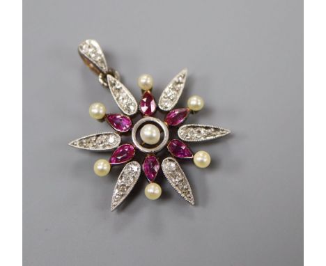 A late Victorian yellow metal, ruby, diamond and seed pearl set starburst pendant brooch, with diamond set bale, overall 33mm