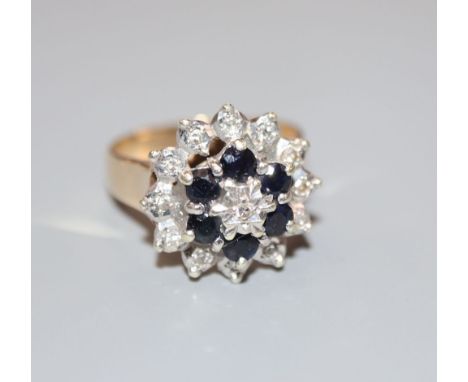 A modern 9ct gold, sapphire and diamond cluster ring, size M, gross 4.9 grams.