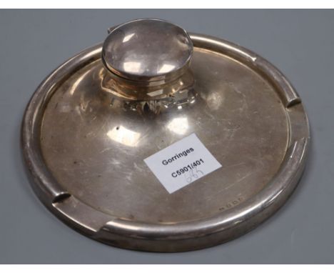 A George V silver circular inkwell, the rim with pen recess, Deakin &amp; Francis, Birmingham, 1929, 19.7cm, weighted.CONDITI