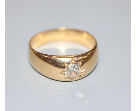 A late Victorian yellow metal and gypsy set solitaire diamond ring, size R, gross 7 grams.CONDITION: Hallmarks rubbed. Probab