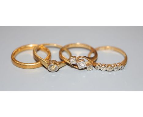 A 22ct gold wedding ring, 4.4 grams and three 18ct gold diamond-set rings, gross 5.9 grams.CONDITION: 5 stone- Settings are q