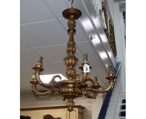 A carved giltwood six branch chandelier ceiling light