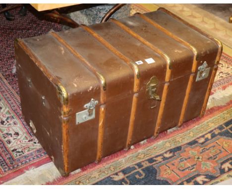 An early 20th century travelling trunk containing a large quantity of assorted linen and mixed textiles, trunk W.90cm