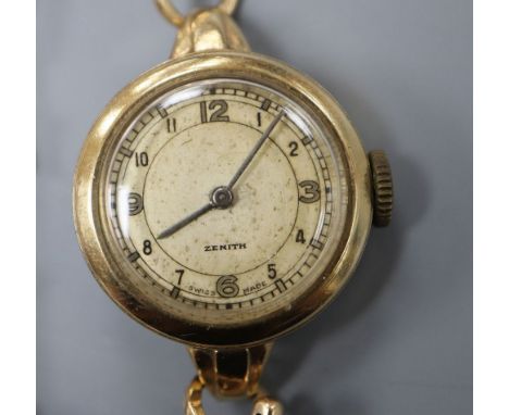 A lady's 1950's 9ct gold Zenith manual wind wrist watch, with case back inscription, on a 9ct expandable strap, gross weight 