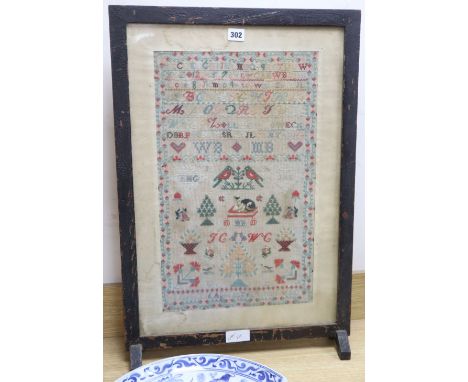 A needlework sampler dated 1886, framed as a firescreen, overall height 71cm