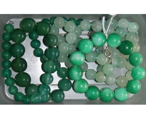 Two simulated jade necklaces and a stained jade? bracelet.