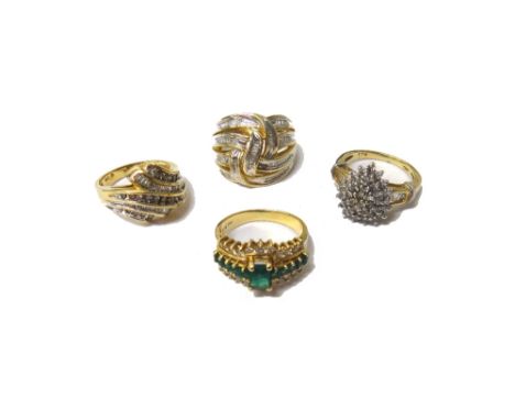 A gold, emerald and diamond set ring, claw set with the principal rectangular cut emerald at the centre, between two rows of 