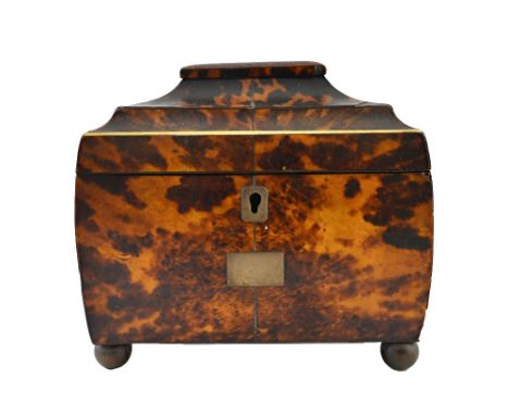 A George III tortoiseshell tea caddy with twin lidded interior, on bun feet, 16cm wide.  Illustrated