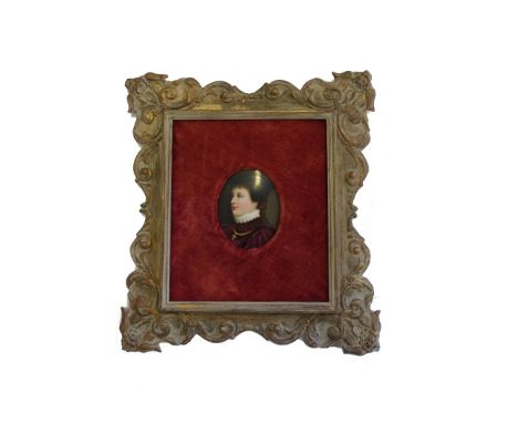 A Continental porcelain oval portrait miniature, late 19th century, depicting a lady in a purple ruffed robe, housed in a gil