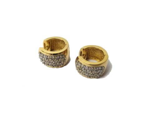 A pair of gold and diamond set earrings, each in a hinged curved design, mounted with three rows of circular cut diamonds, de