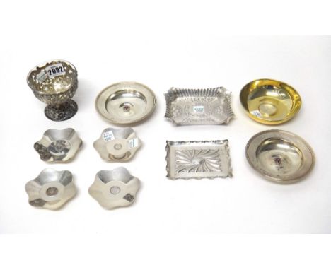 A group of silver wares, to include; a pair of Armada dishes with applied enamel badges, a set of four pin dishes inset with 