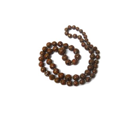 A single row necklace of mother of pearl inlaid Japanese lacquered spherical beads, graduating in size to the front and a jad