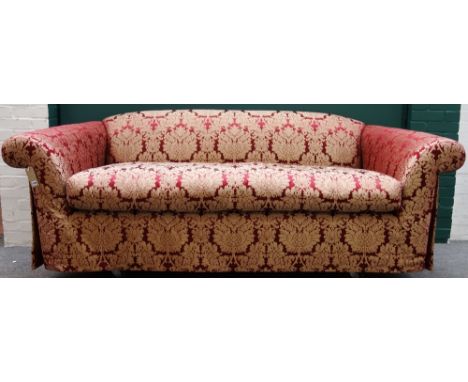 A 20th century red and golden thistle upholstered sofa on outswept arms, 245cm wide.