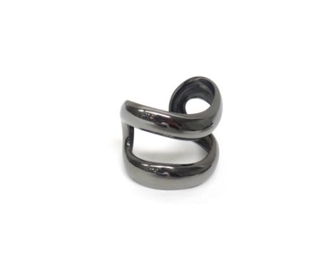 A Tiffany &amp; Co Elsa Perretti bangle, in an openwork abstract curved design, having a gun metal finish, detailed Tiffany &