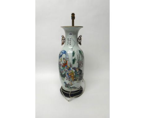 A large Chinese famille-rose two-handled baluster vase, 20th century, painted with four figures and a water buffalo, the reve