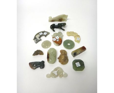 A group of fourteen Chinese jade and hardstone carvings, some in archaic style, including; a celadon jade bi disc carved with