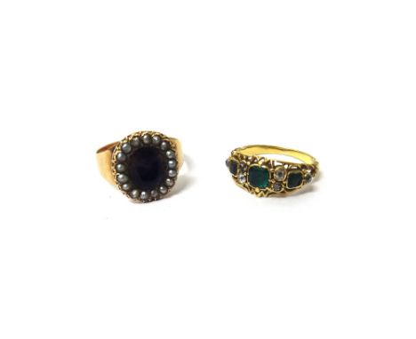 A Victorian gold, emerald and diamond set ring, mounted with the principal emerald at the centre, between two pairs of cushio