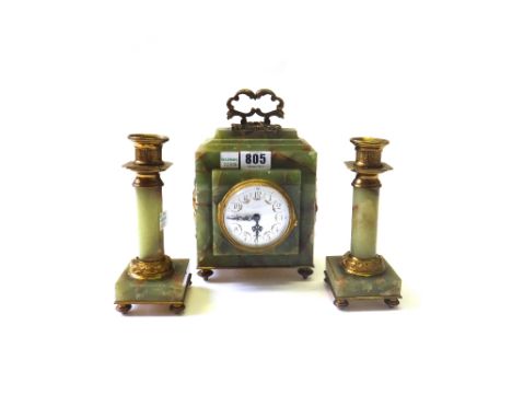 An onyx and ormolu mounted clock garniture, early 20th century, with foliate decorated white enamel dial and later quartz mov