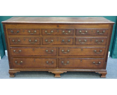 A mid 18th century mahogany banded oak mule chest, the lift top over two rows of three dummy drawers, above four true drawers