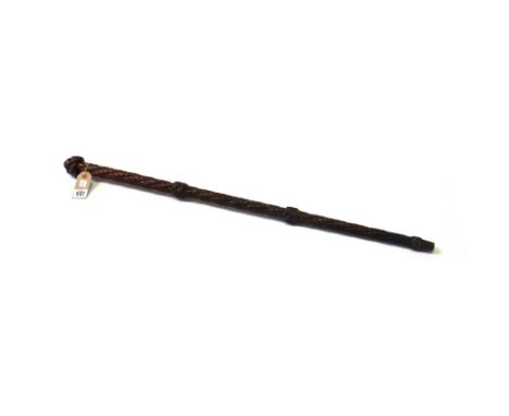 A hardwood walking cane, 19th century carved all over with a rope twist pattern, with large 'knot' finial and two smaller dec