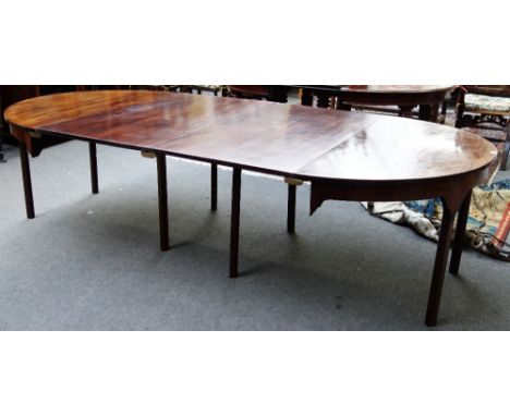 A George III mahogany 'D' end dining table on eight canted square supports, to include two extra leaves, 135cm wide, each con