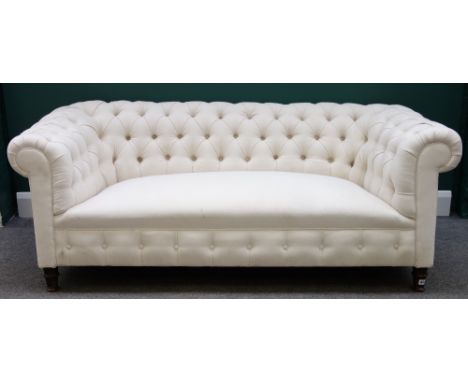 A late 19th century cream button upholstered Chesterfield sofa on turned mahogany supports, 184cm wide. 