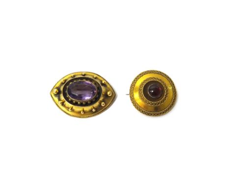 A Victorian gold and amethyst set single stone brooch, collet set with an oval cut amethyst, within a beaded border and with 