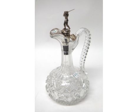 A facet cut glass claret jug with a silver mounted cork, the finial designed as a golfer, by Johnson, Walker and Tolhurst Lon