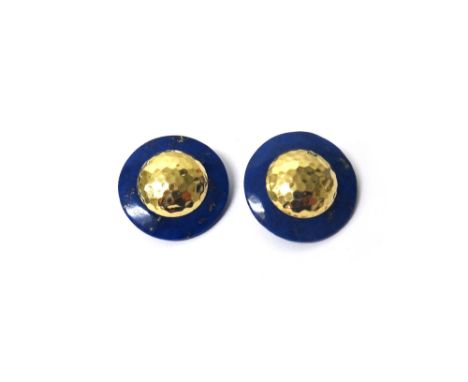 A pair of gold mounted lapis lazuli circular earclips, each having a domed centre, with a simulated beaten finish, detailed 1