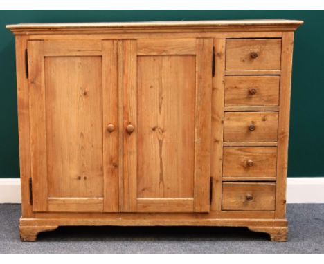 A 19th century pine side cabinet, with pair of panel doors enclosing shelves, mounted with five short drawers to the right ha