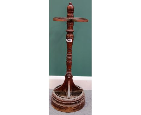 A Victorian oak and metal mounted four division stick stand, with turned column and stepped circular base, 86cm high.