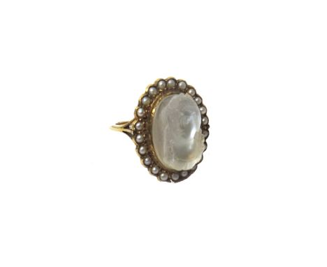 A gold, carved moonstone cameo and seed pearl set ring, mounted with the oval carved moonstone cameo at the centre, designed 