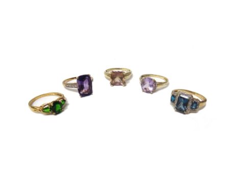 A 9ct gold ring, claw set with a cushion shaped amethyst between diamond set four stone shoulders, two 9ct gold, diamond and 
