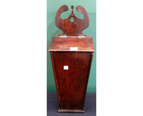 A George III oak hanging candle box, with fret carved hanging bracket over tapering body, 52cm high.