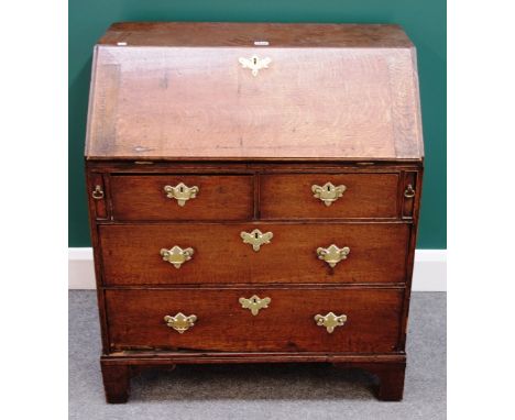 A small 18th century oak bureau, the fitted interior over two short and two long drawers, on bracket feet, 76cm wide x 89cm h