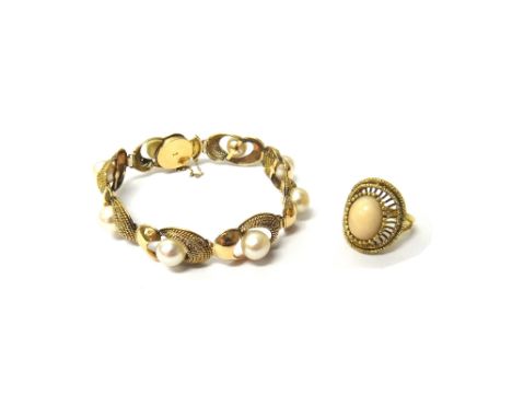 A gold and cultured pearl bracelet, the shaped oval twin section links, centred by cultured pearls, on a snap clasp, detailed