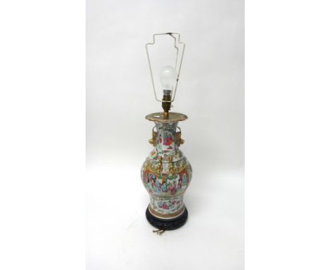 A Canton famille-rose baluster vase, 19th century, painted with figurative panels, the shoulders and neck applied with gilt c