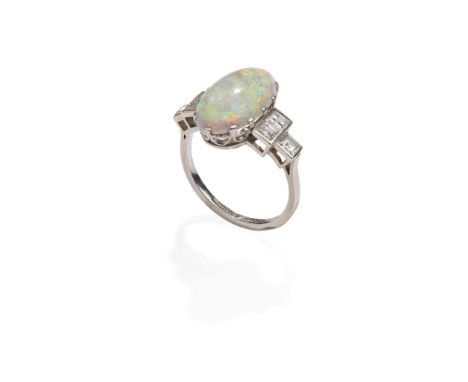 An Art Deco opal and diamond ring, circa 1930 The oval cabochon opal, between square-cut diamond three-stone shoulders, later