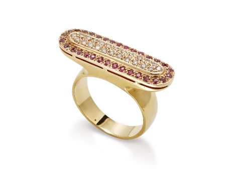 A ruby and diamond dress ring The elongated oval plaque pavé-set with brilliant-cut diamonds within a circular-cut ruby surro