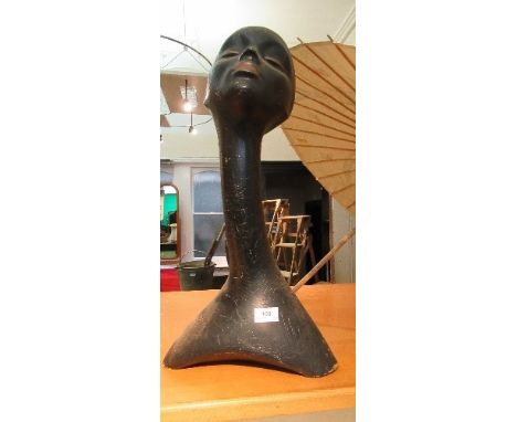 A black Art Deco style leather lady's head mannequin, with elongated neck
