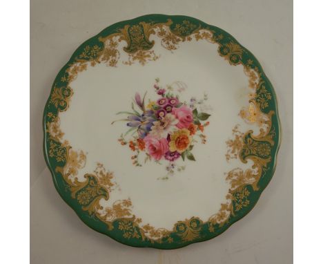 A Royal Worcester plate, decorated with a central panel of flowers by Ernest Phillips, to a shaped gilt and green border, cir