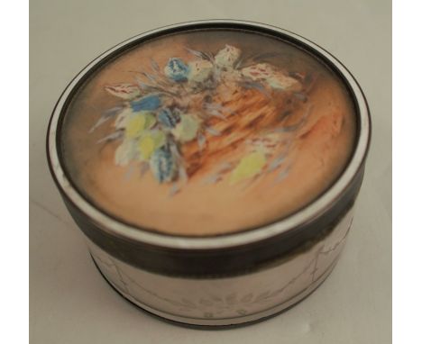 A silver mounted and glass dressing table box, of circular form, the top inset with a signed watercolour of a still life of f