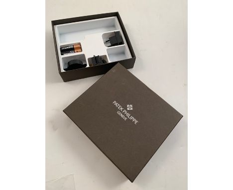 A Patek Philippe box containing various plugs