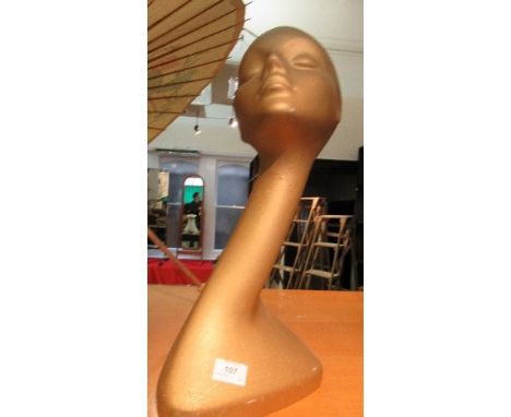 A gold coloured Art Deco style cast lady's head mannequin, with elongated neck